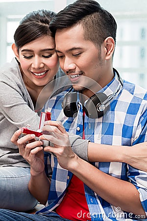 Young Indonesian man makes proposal to girlfriend Stock Photo