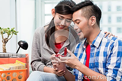 Young Indonesian man makes proposal to girlfriend Stock Photo