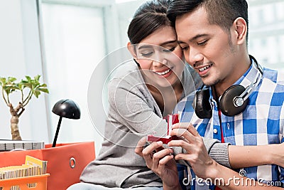 Young Indonesian man makes proposal to girlfriend Stock Photo