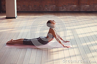 Young instructor doing yoga indoors Stock Photo