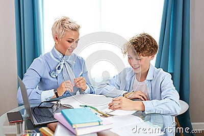 Young intelligent teacher explain math or geometry to student Stock Photo