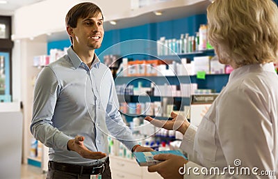 Young interested man in drugstore Stock Photo