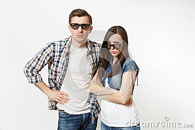 Young irritated dissatisfied couple, woman and man in 3d glasses and casual clothes watching movie film on date, keeping Stock Photo