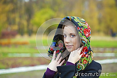 Young Italians in coat and knit a scarf on her head Stock Photo