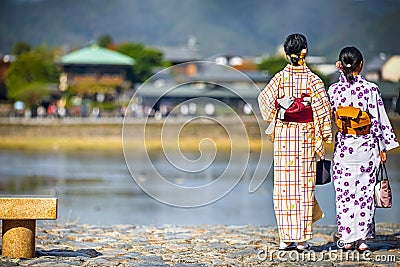 Young Japanese Girls Wearing Traditional Geisha`s Kimono In Front of Pond in Kyoto, Japan Editorial Stock Photo
