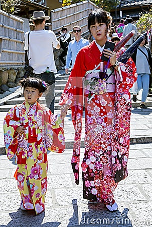 A young Japanese mother with a little daughter in bright kimono Editorial Stock Photo
