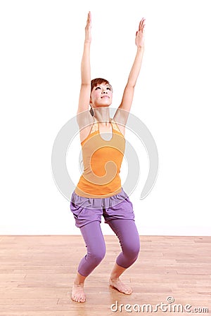 Young Japanese Woman Doing YOGA chair pose Stock Photo