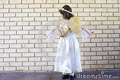 Young Jewish girl dressed up in angel costume on Purim Jewish holiday Stock Photo
