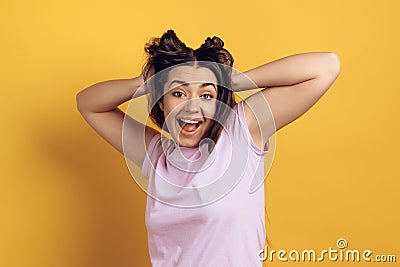 Young joyous girl ruffles long hair on head. Stock Photo