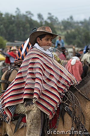 Young kichwa boy wearing a poncho on horseback Editorial Stock Photo