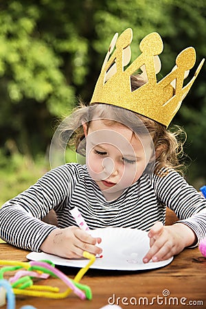 Young kid enjoying painting Stock Photo