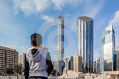 Young kid looking at Abu Dhabi city - Architecture and famous skyscrapers of Abu Dhabi skyline with beautiful clouds Editorial Stock Photo