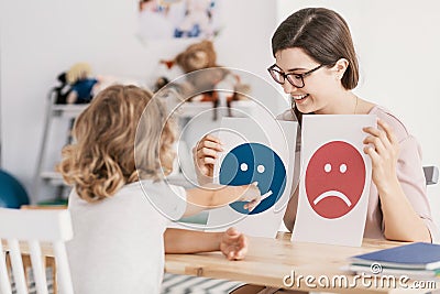 Young kid pointing at graphic with a smiley face during a psycho Stock Photo