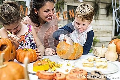 Young kids carving Halloween jack-o`-lanterns Stock Photo