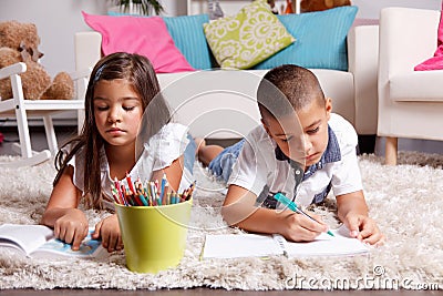 Young kids doing homework at home Stock Photo