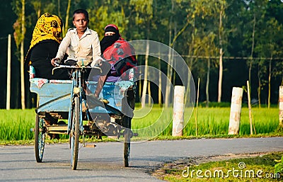 Young kids riding a three wheelers in an urban road Editorial Stock Photo