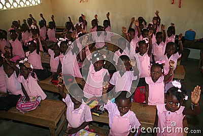Young kindergarten Haitian school girls and boys show friendship bracelets in school classroom. Editorial Stock Photo