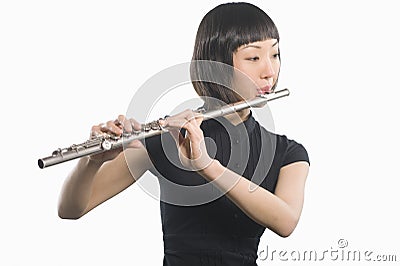 Young Korean Woman Playing Flute Stock Photo