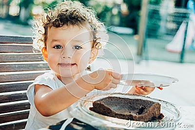 Young lady enjoys a chocolate cake for a snack Stock Photo