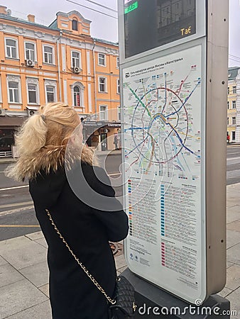 Young lady looking at transport map Editorial Stock Photo