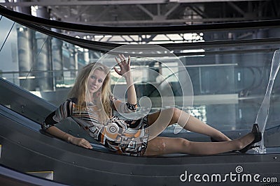 Young lady lying on escalator Stock Photo