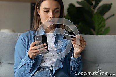 Young lady making purchase at internet shop using cell Stock Photo