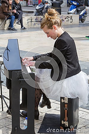 Young lady playing electric piano at Aristotelous square Editorial Stock Photo