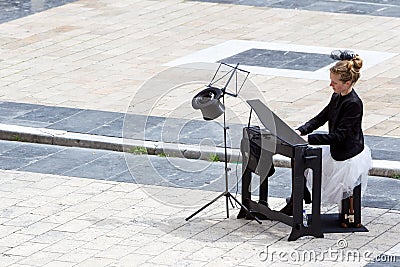 Young lady playing electric piano at Aristotelous square Editorial Stock Photo