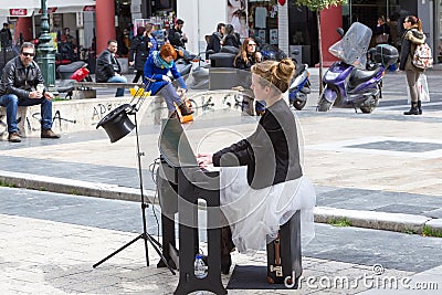 Young lady playing electric piano at Aristotelous square Editorial Stock Photo