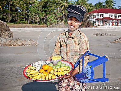 Young lady sells fresh fruit along the beach Editorial Stock Photo