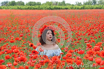 Young lady sitiing in poppies Stock Photo