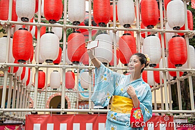 Young lady standing in front of the lantern wall Stock Photo