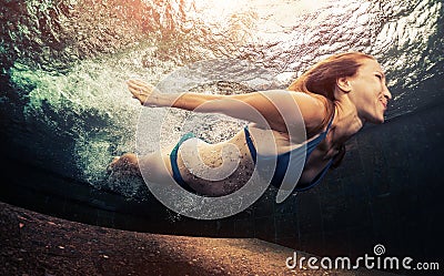 Young lady swimming underwater Stock Photo