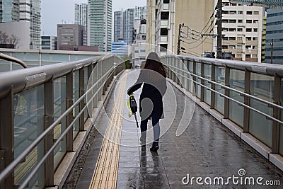 Lady walking in the rainy city of Tokyo, Japan Editorial Stock Photo