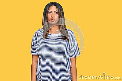 Young latin girl wearing casual clothes making fish face with lips, crazy and comical gesture Stock Photo