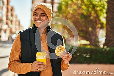 Young latin man smiling happy having breakfast at the city Stock Photo
