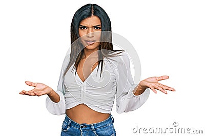 Young latin transsexual transgender woman wearing casual clothes clueless and confused with open arms, no idea concept Stock Photo