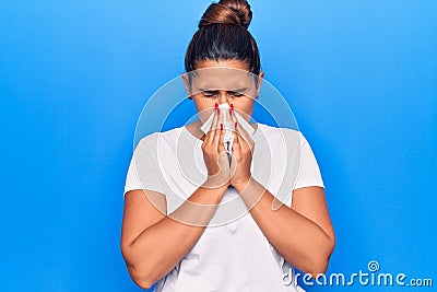 Young latin woman illness using paper handkerchief on nose Stock Photo