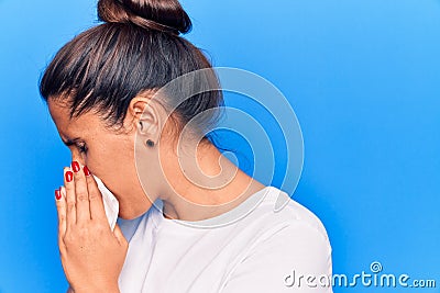 Young latin woman illness using paper handkerchief on nose Stock Photo