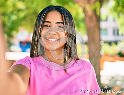 Young latin woman smiling happy making selfie by the camera at the park Stock Photo