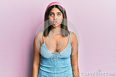 Young latin woman wearing summer clothes making fish face with lips, crazy and comical gesture Stock Photo