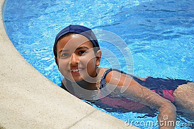 Young latinamerican girl in the swimming pool. Stock Photo