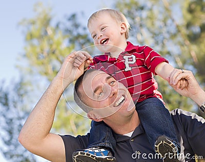 Young Laughing Father and Child Piggy Back Stock Photo