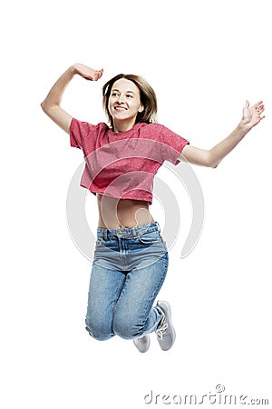 Young laughing jumping girl in a red tank top and jeans. Happy time. Isolated on a white background. Vertical Stock Photo
