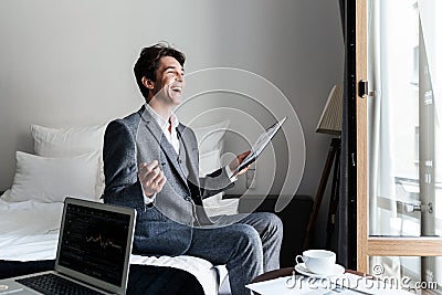 Young laughing male lawyer reviewing some documents Stock Photo