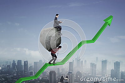 Young leader with his employee on upward arrow Stock Photo