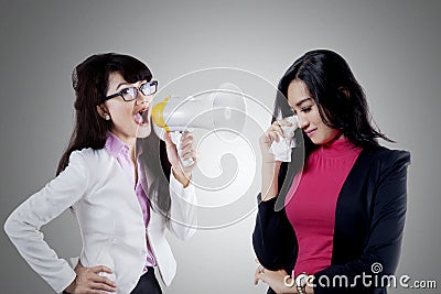 Young leader shouting her employee Stock Photo