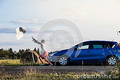 Young Lost Woman Losing a Map Because of the Wind Stock Photo