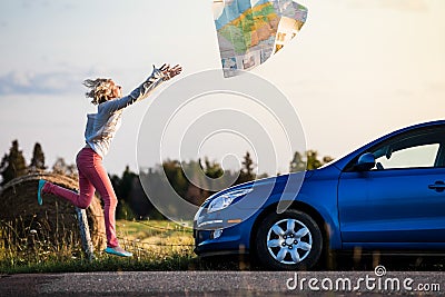 Young Lost Woman Losing a Map Because of the Wind Stock Photo