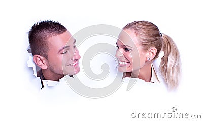 Young love couple peer through the wallpaper Stock Photo